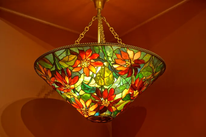 A Tiffany Studios leaded-glass lamp with a poinsettia pattern